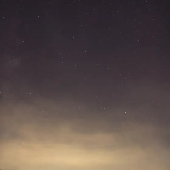 A golden horizon under a crescent moon